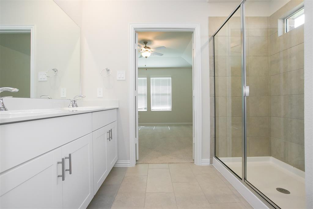 404 Castle Road Sherman, TX 75092 - Photo 11 of 25 a bathroom with a shower sink and mirror