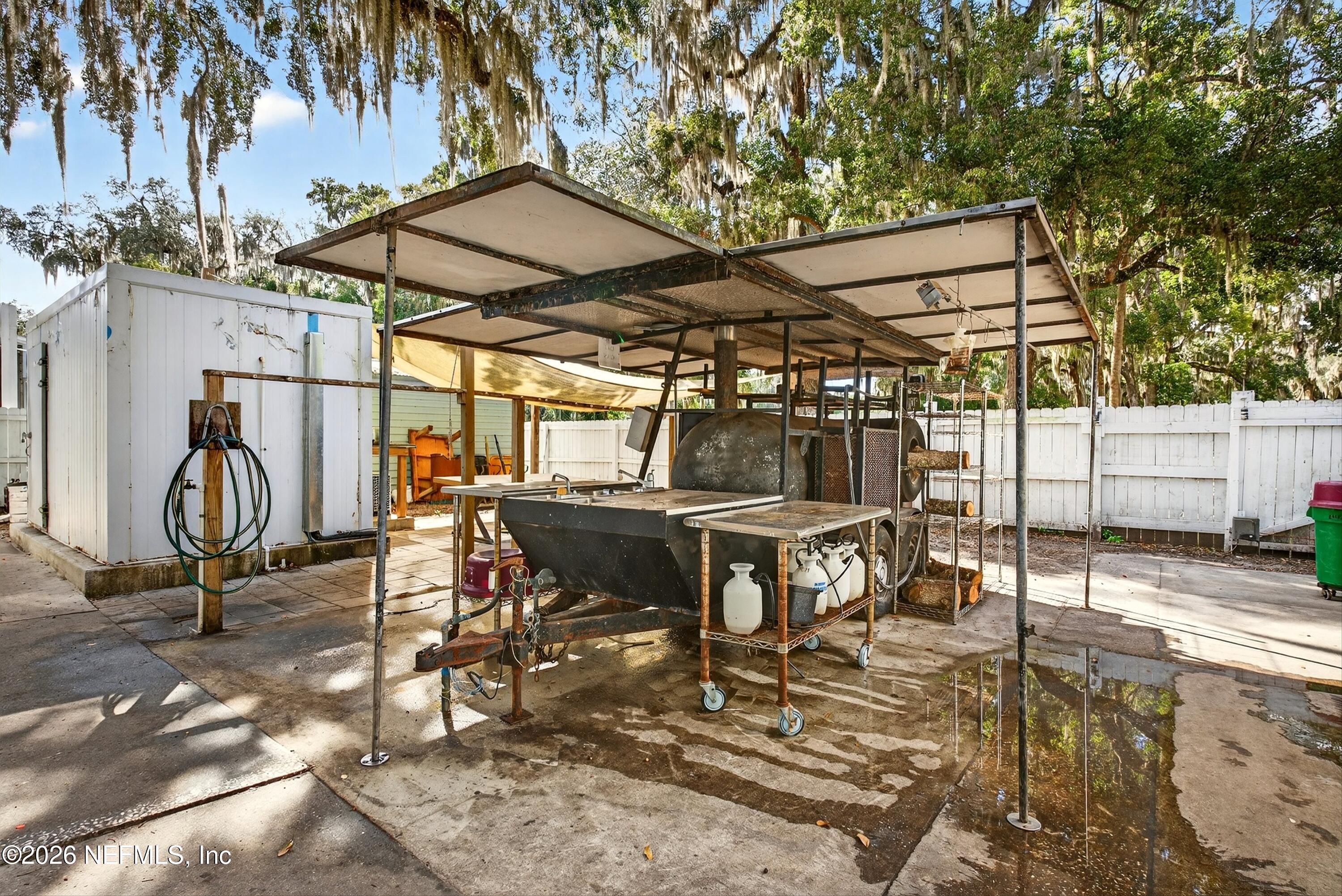 201 Oak Street Welaka, FL 32193 - Photo 103 of 115 a view of a backyard with table and chairs with wooden fence