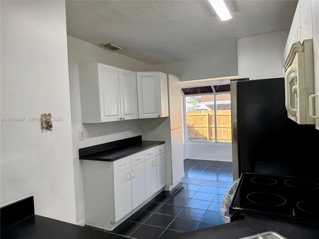 a kitchen with a sink and a refrigerator