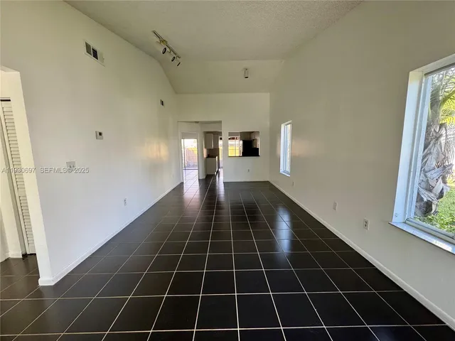 a bathroom with a glass door shower and a window