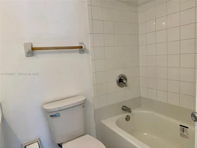 a white bath tub sitting next to a toilet