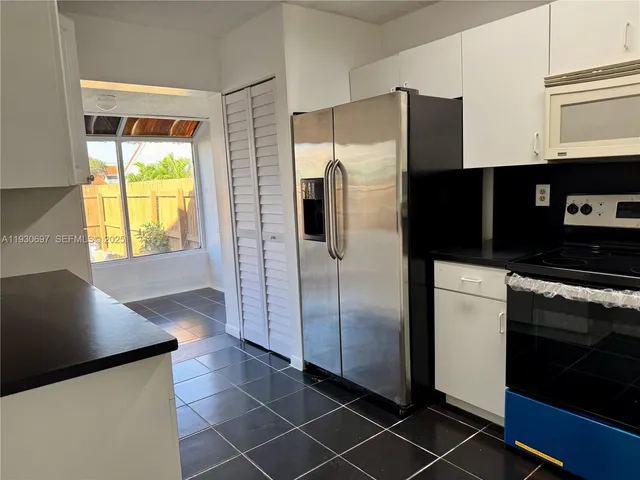 a kitchen with stainless steel appliances a refrigerator and a stove