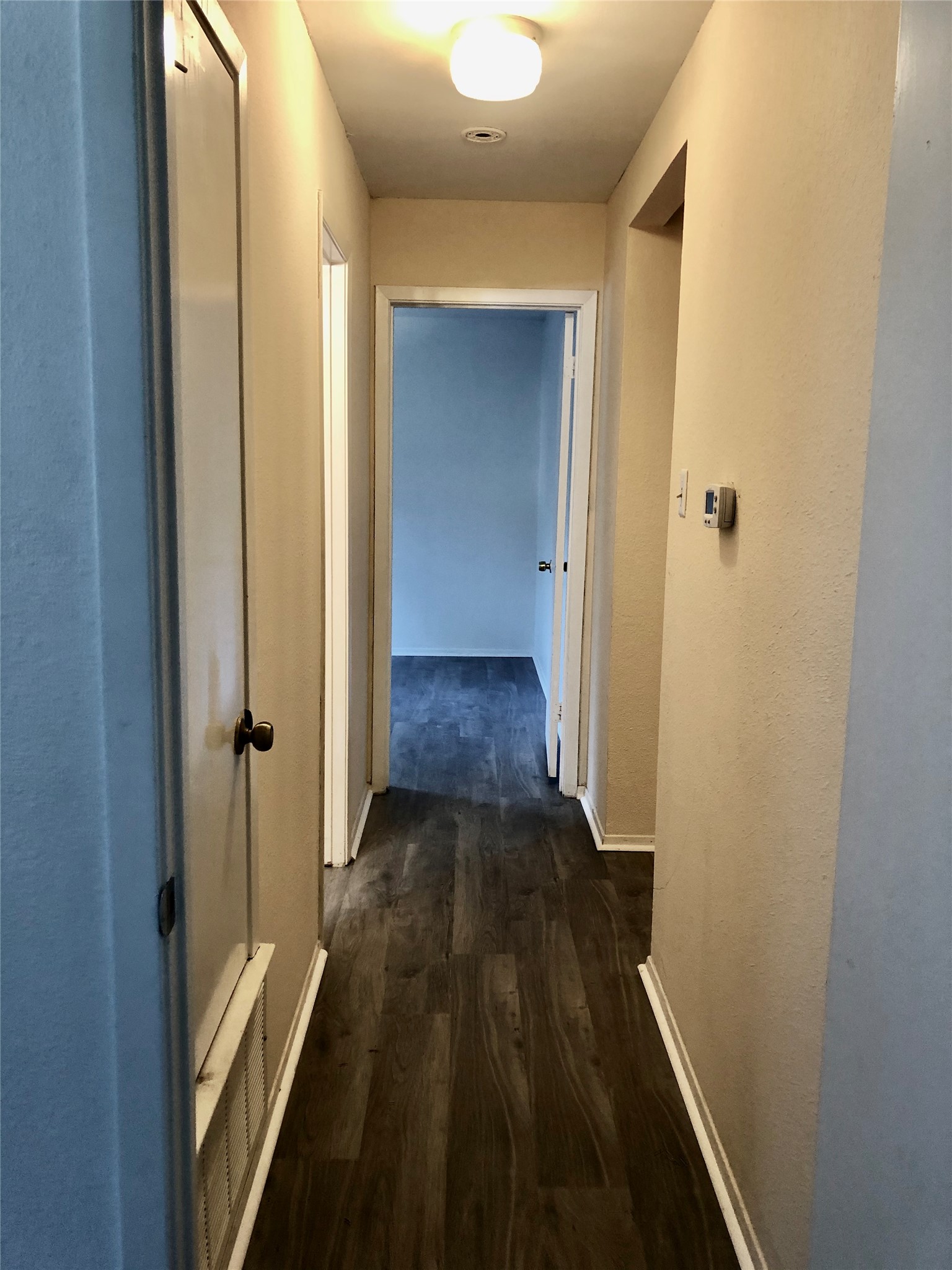 718 Decker Prairie Drive Austin, TX 78748 - Photo 11 of 22 Hall featuring dark wood finished floors and baseboards