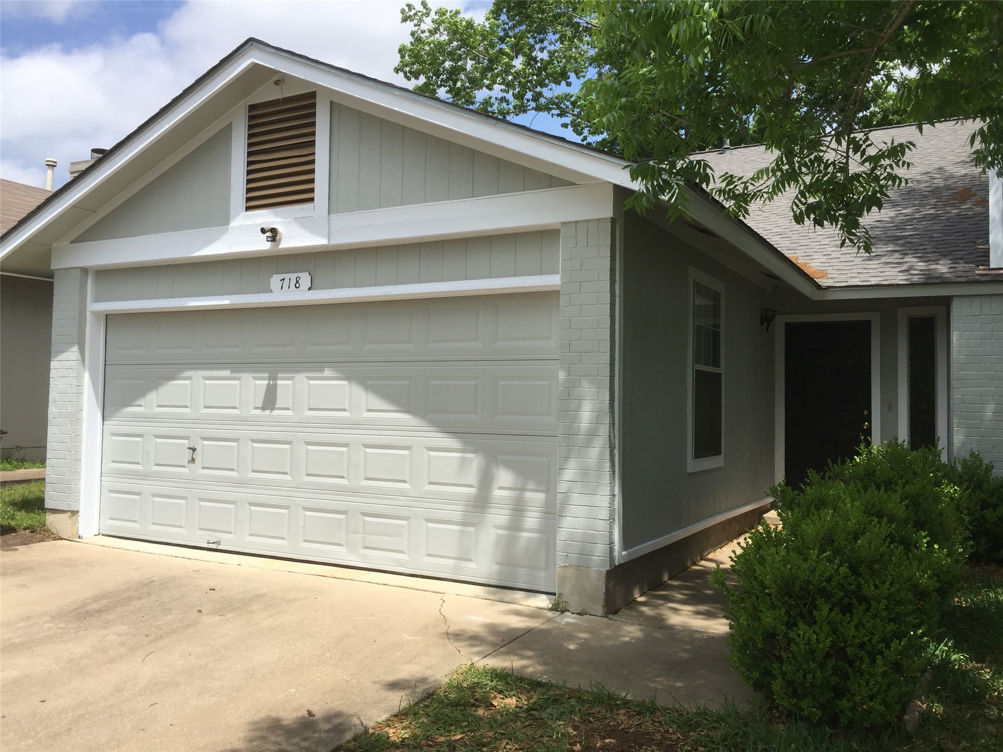 718 Decker Prairie Drive Austin, TX 78748 - Photo 22 of 22 View of side of home with brick siding, a garage, driveway, and a shingled roof