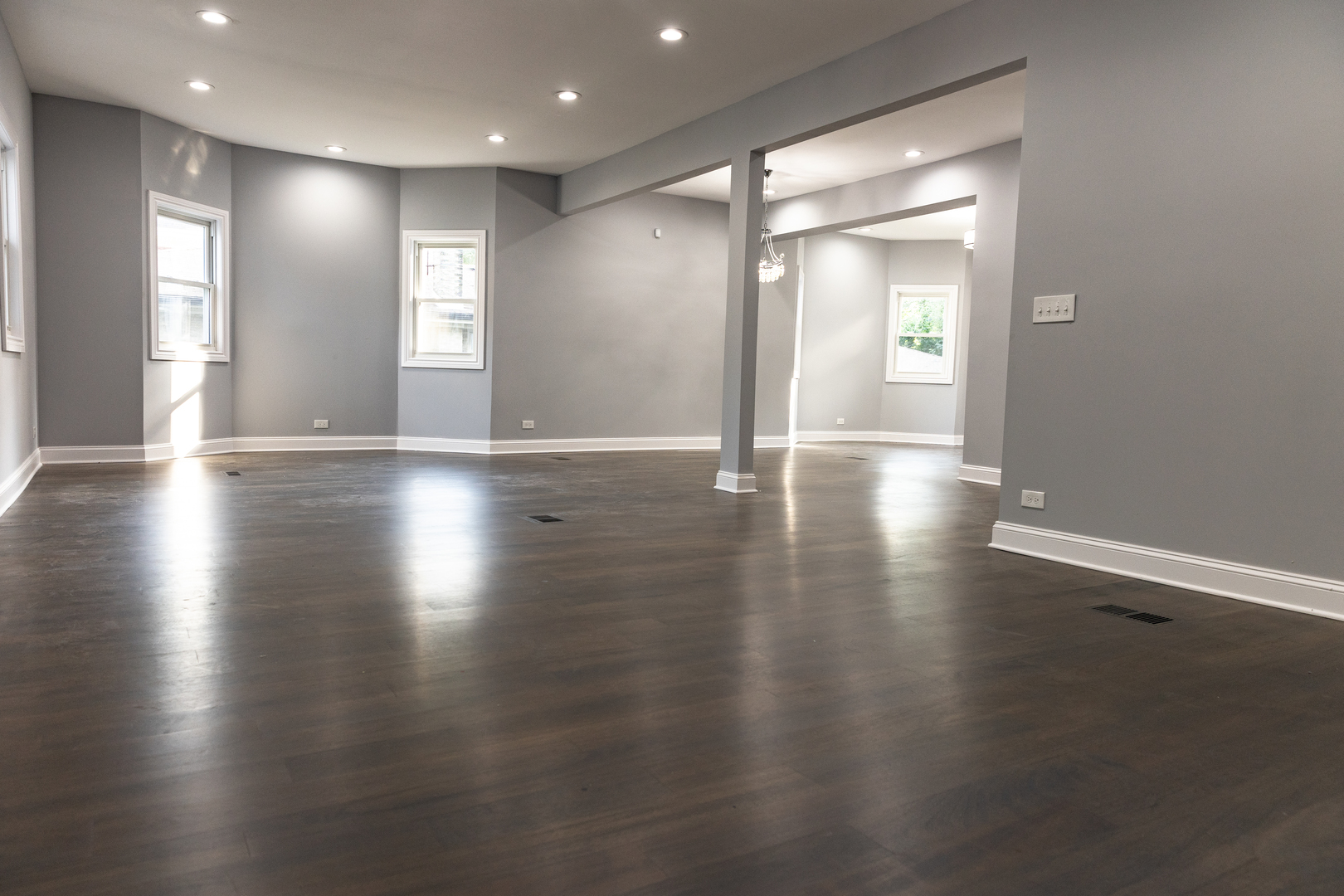 12124 South Stewart Avenue Chicago, IL 60628 - Photo 11 of 71 a view of an empty room with wooden floor and a window