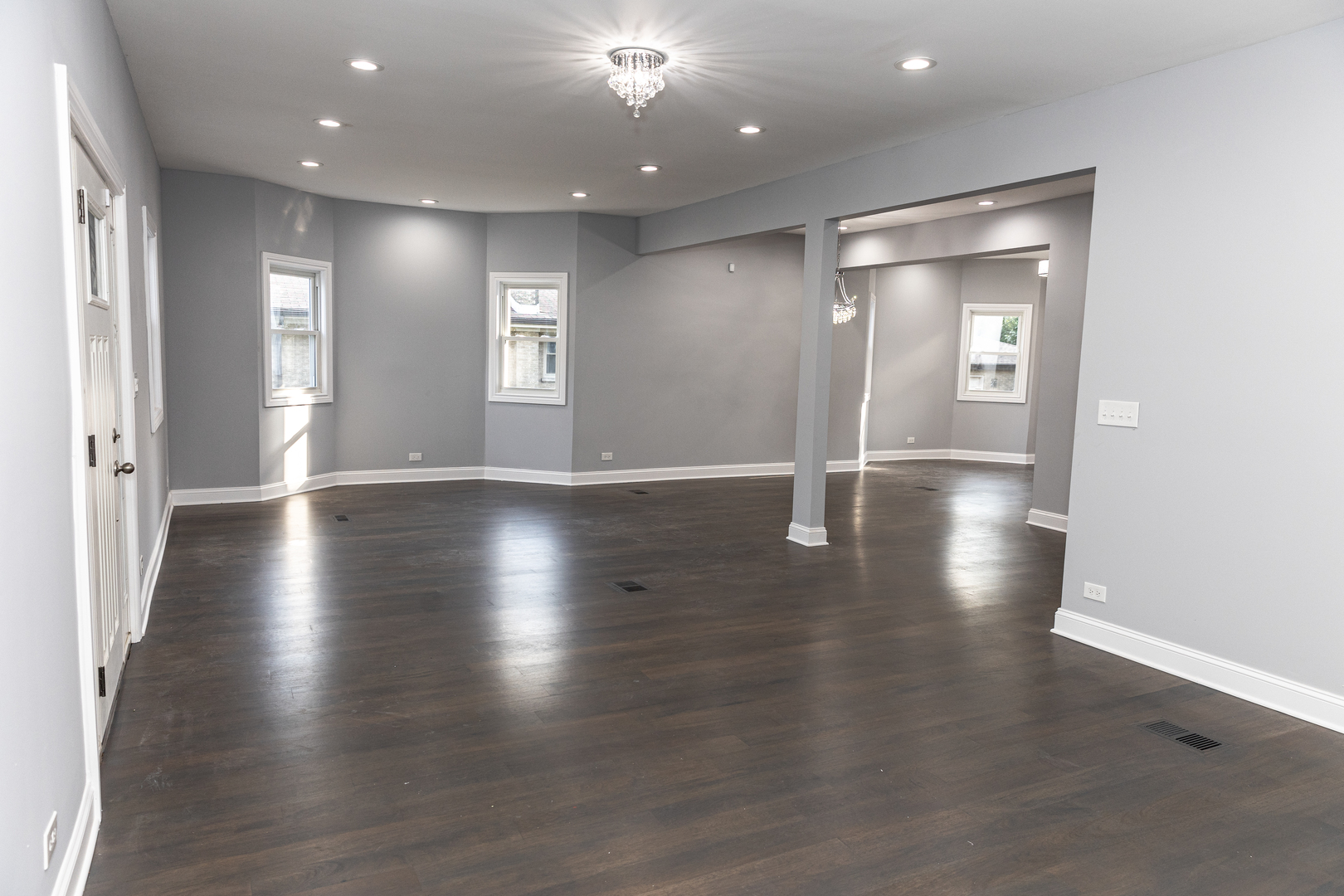 12124 South Stewart Avenue Chicago, IL 60628 - Photo 12 of 71 an empty room with wooden floor and windows