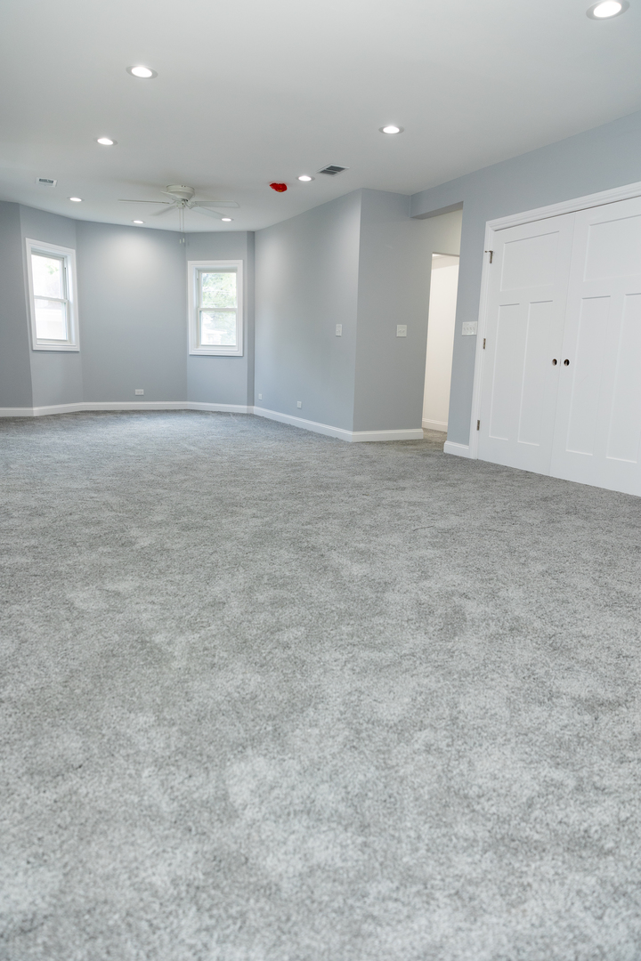 12124 South Stewart Avenue Chicago, IL 60628 - Photo 41 of 71 an empty room with windows and ceiling fan