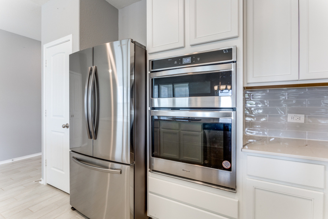 1100 Desaix Drive Georgetown, TX 78628 - Photo 12 of 25 a kitchen with cabinets and stainless steel appliances
