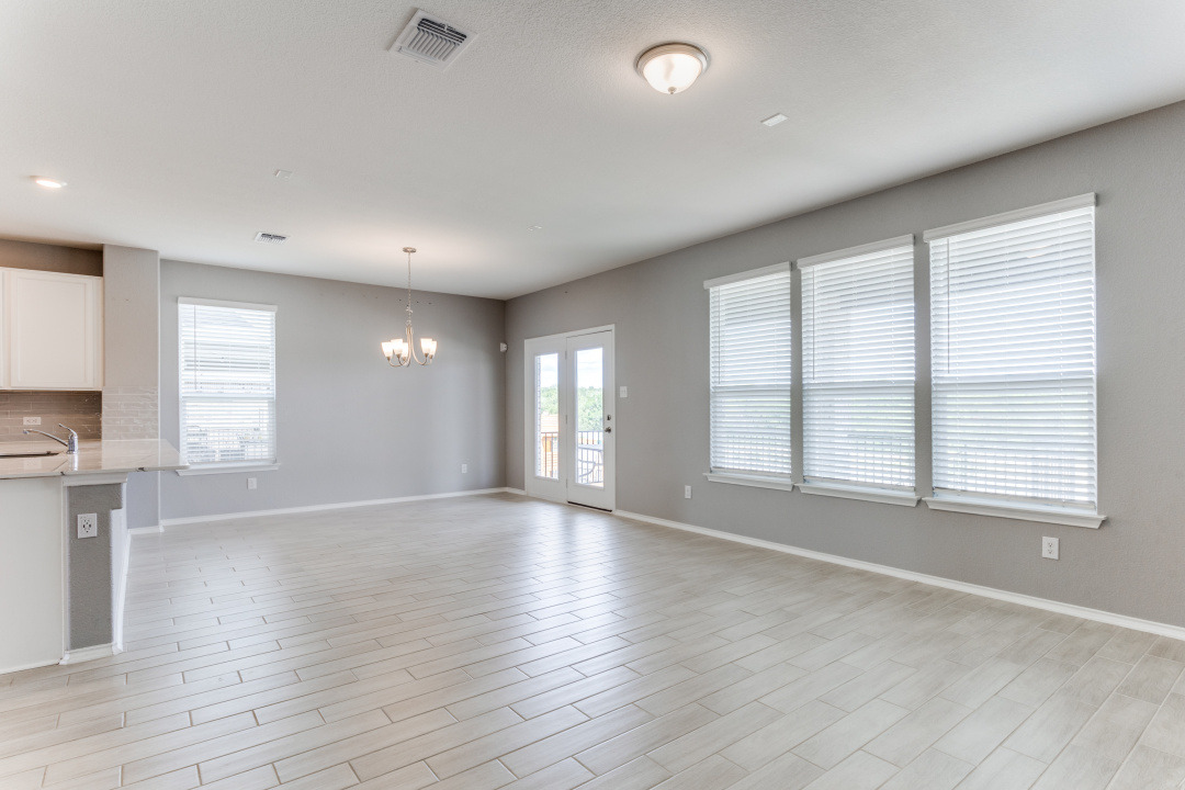 1100 Desaix Drive Georgetown, TX 78628 - Photo 13 of 25 an empty room with wooden floor and windows