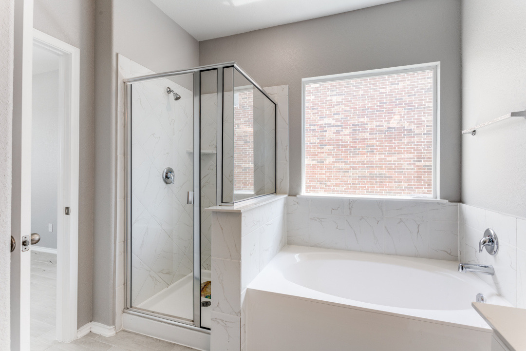1100 Desaix Drive Georgetown, TX 78628 - Photo 23 of 25 a bathroom with a bathtub and a shower