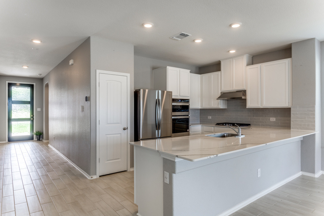 1100 Desaix Drive Georgetown, TX 78628 - Photo 6 of 25 a kitchen with stainless steel appliances granite countertop a refrigerator and a sink