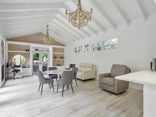 a dining room with furniture and a chandelier