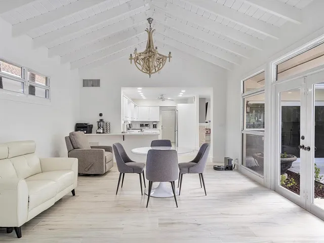 a view of a dining room with furniture wooden floor and a chandelier