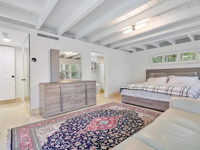 a bedroom with a bed and cabinets