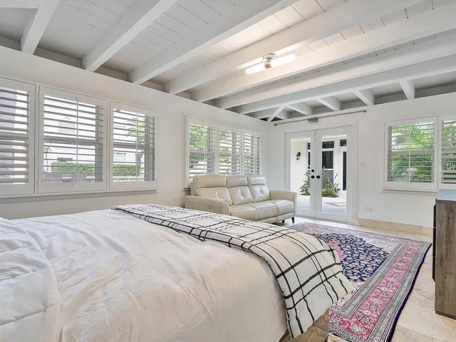a bedroom with a bed next to a window