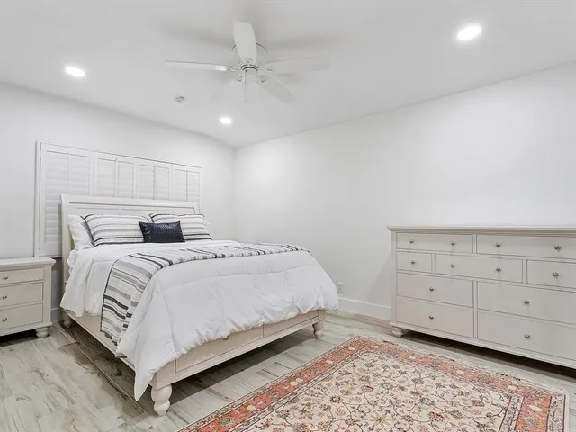 a bedroom with a bed and a night stand