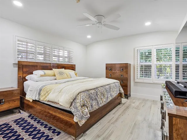 a bedroom with a large bed and a large window