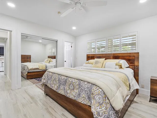 a bedroom with a large bed and a chandelier