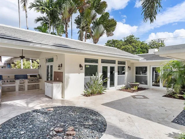 a view of a house with backyard sitting area and porch