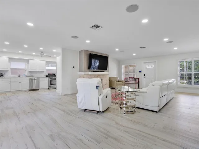 a living room with furniture and kitchen view