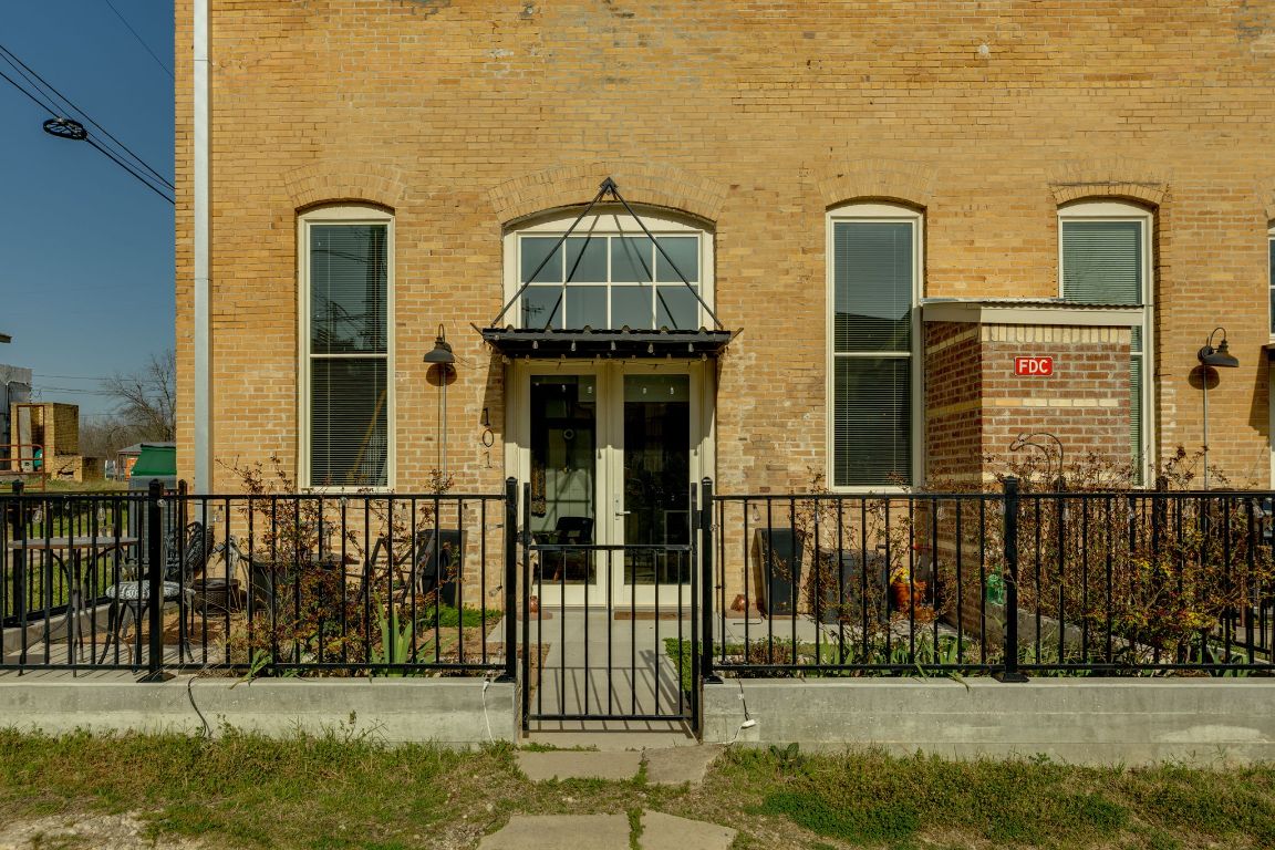 a view of a brick house with a yard