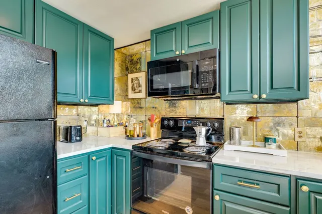 a kitchen with stainless steel appliances granite countertop a sink stove and cabinets