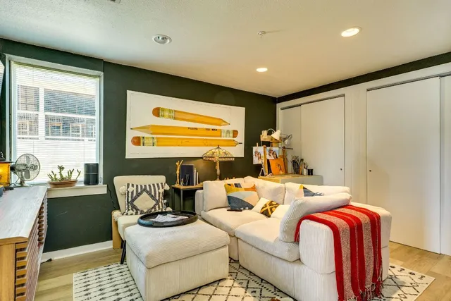 a bedroom with furniture and a large window