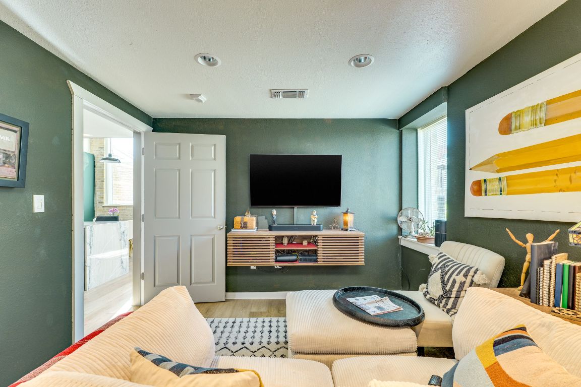 110 South Main Street, Unit 101 Elgin, TX 78621 - Photo 18 of 35 a living room with furniture and a flat screen tv