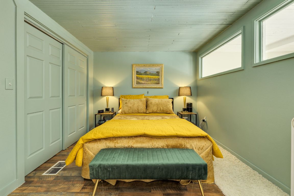 110 South Main Street, Unit 101 Elgin, TX 78621 - Photo 27 of 35 a bed sitting in a bedroom next to a window