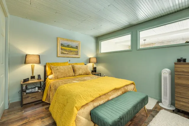 a bedroom with a bed and a chair