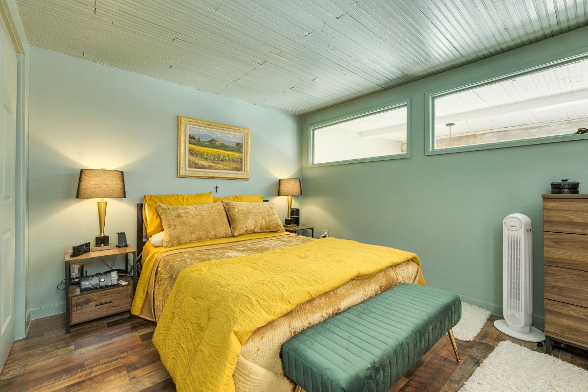 110 South Main Street, Unit 101 Elgin, TX 78621 - Photo 28 of 35 a bedroom with a bed and a chair