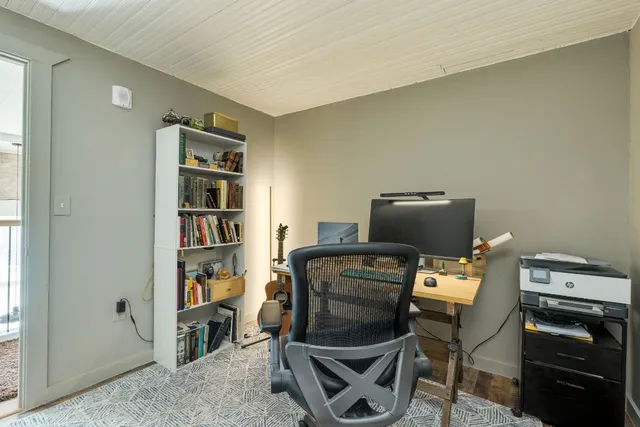 a living room with furniture a air conditioner and a window