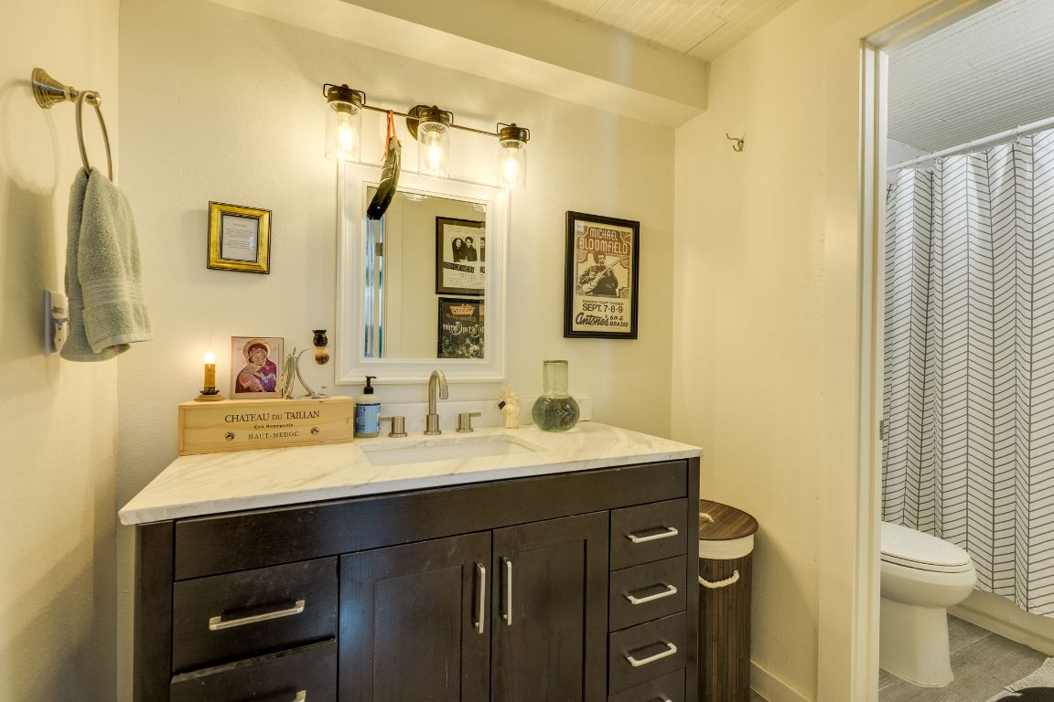 110 South Main Street, Unit 101 Elgin, TX 78621 - Photo 31 of 35 a bathroom with a sink vanity and a mirror