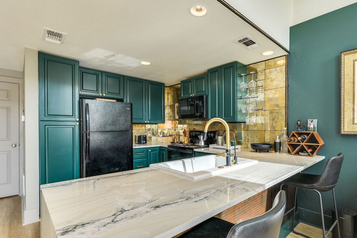 110 South Main Street, Unit 101 Elgin, TX 78621 - Photo 33 of 35 a kitchen with refrigerator and a table
