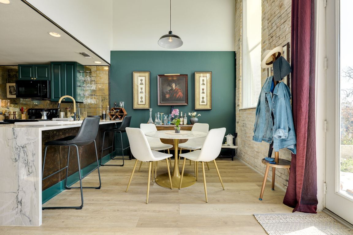 110 South Main Street, Unit 101 Elgin, TX 78621 - Photo 7 of 35 a dining room with furniture a rug a potted plant and a chandelier