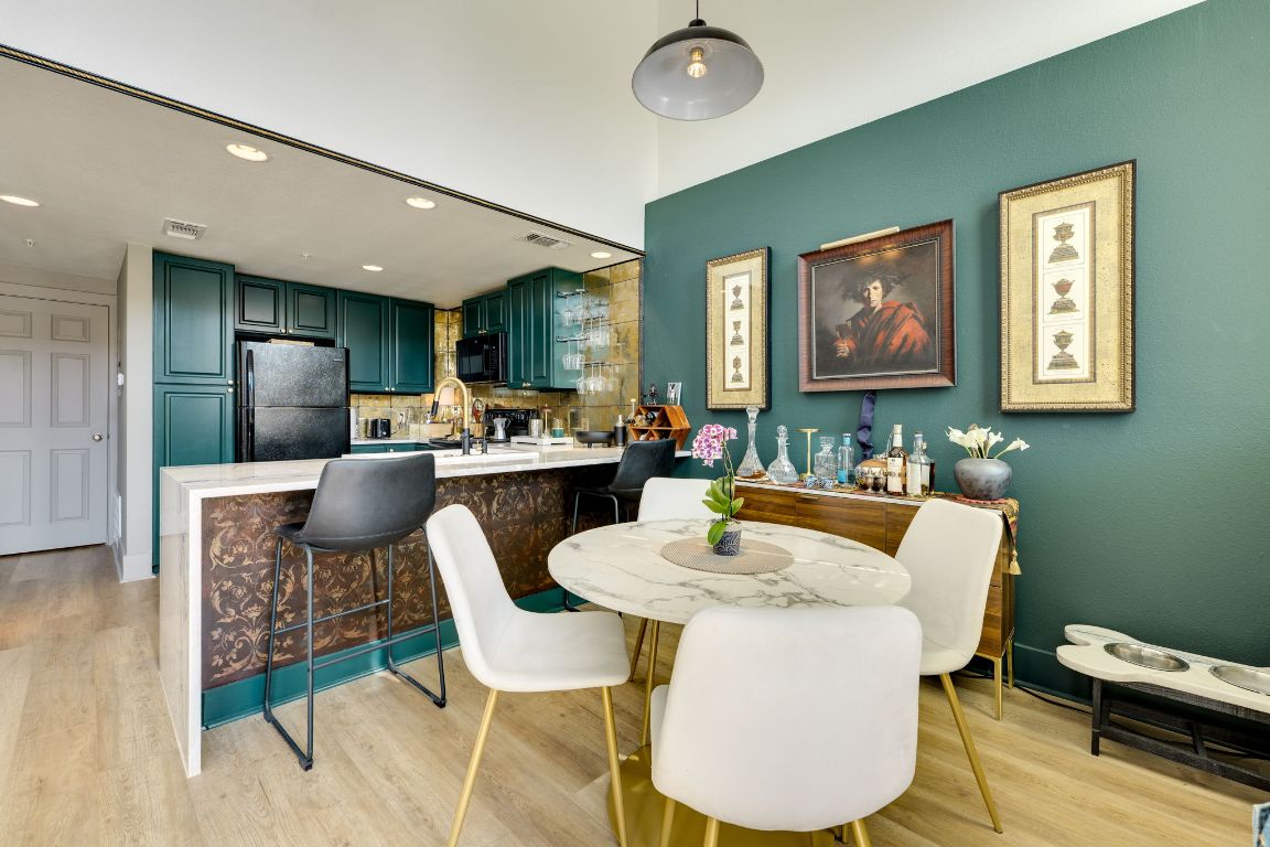 110 South Main Street, Unit 101 Elgin, TX 78621 - Photo 8 of 35 a living room with stainless steel appliances furniture a rug and a kitchen view