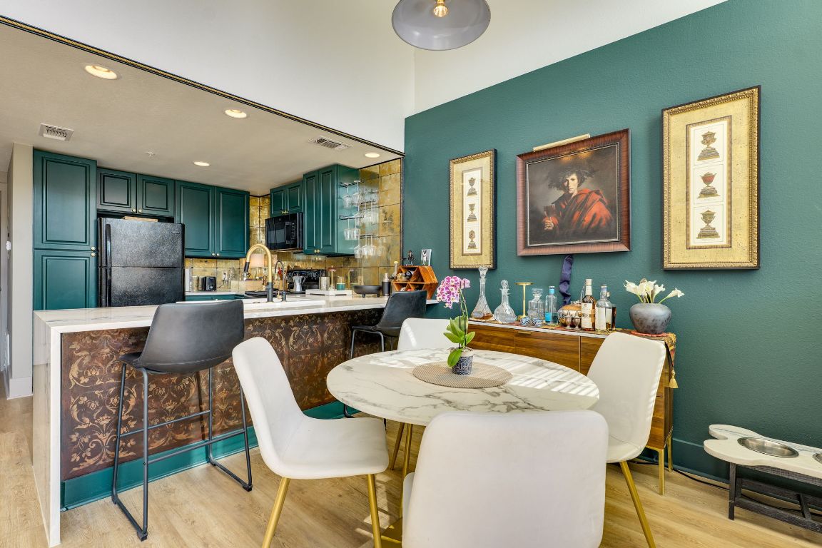 110 South Main Street, Unit 101 Elgin, TX 78621 - Photo 10 of 35 a kitchen with a table chairs refrigerator and dining table