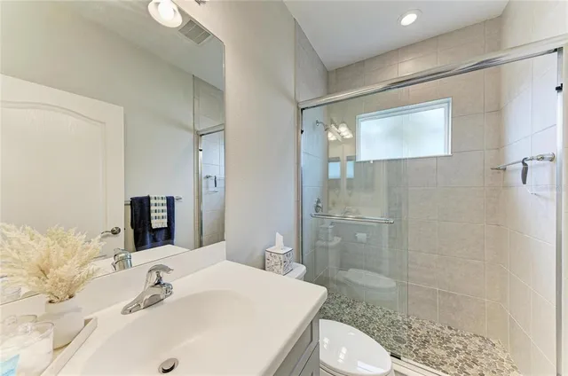 a living room with patio furniture and a garden