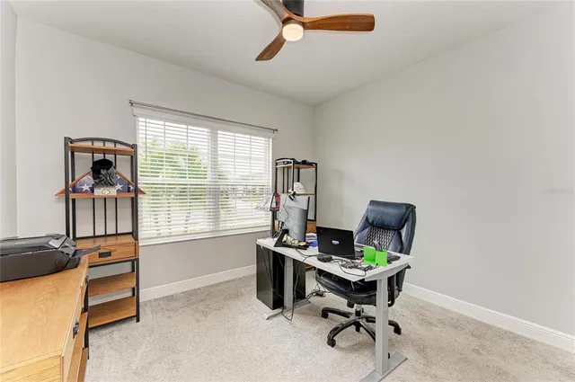 a view of a backyard with table and chairs under an umbrella