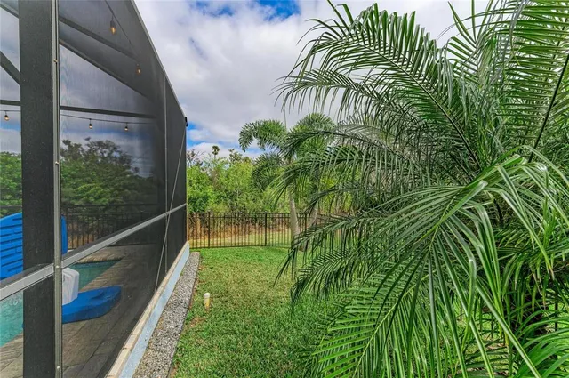 an aerial view of a house with swimming pool and outdoor seating