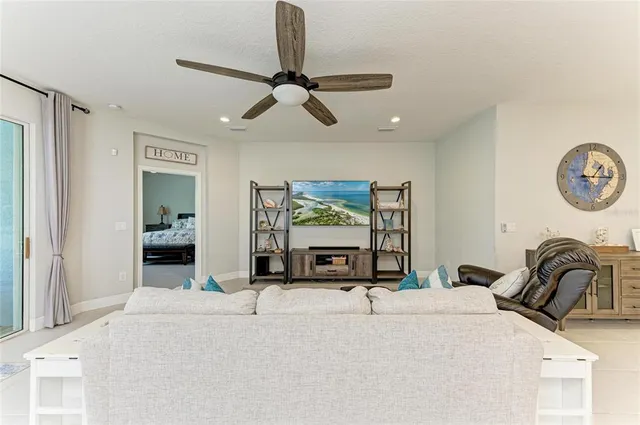 a living room with furniture and a view of kitchen