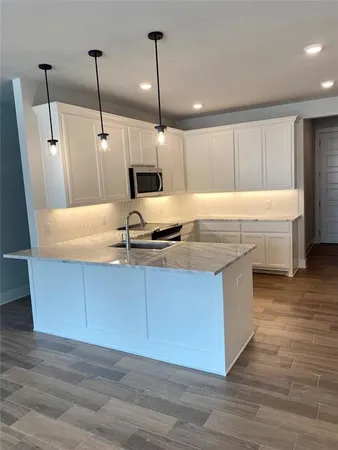 a kitchen with kitchen island a sink a counter space and a window
