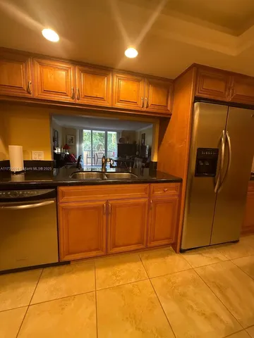 a kitchen with stainless steel appliances granite countertop a sink and cabinets