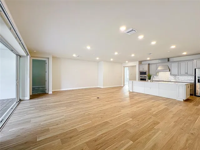 a spacious bathroom with a double vanity sink a mirror and a shower