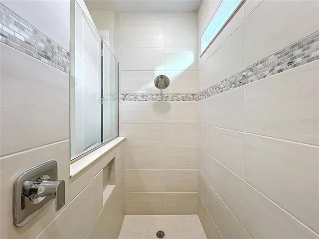 a bathroom with a granite countertop sink a toilet and a large mirror