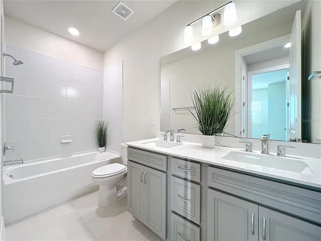 an aerial view of residential houses with outdoor space and ocean view