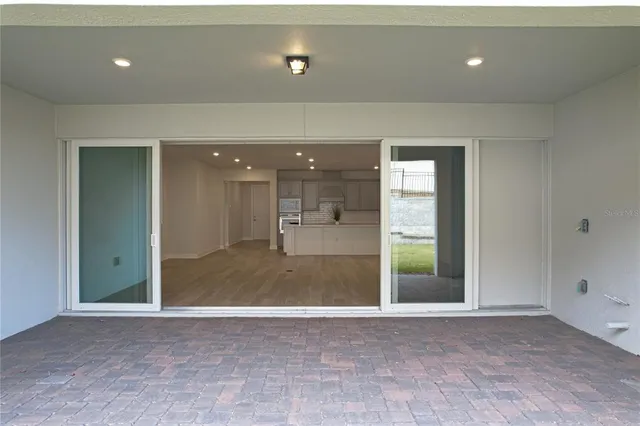 a view of a swimming pool with a bench and trees in the background