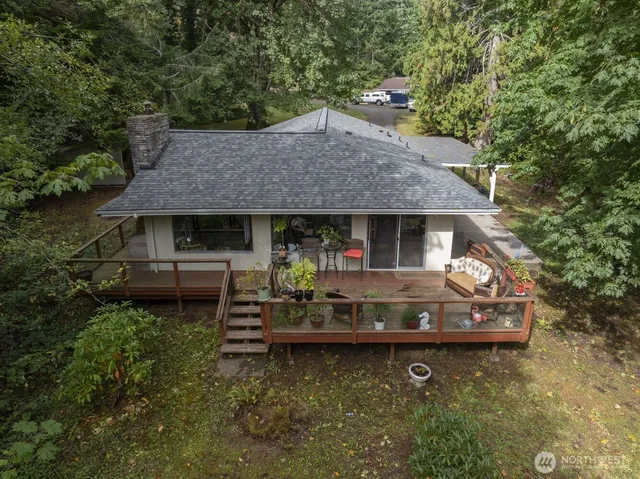 a front view of house with a garden and swimming pool