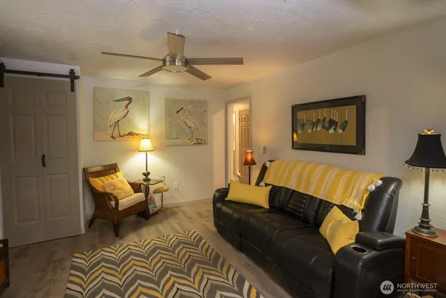 a living room with furniture and a lamp
