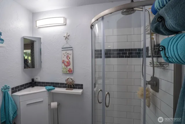 a bathroom with a sink a toilet and shower